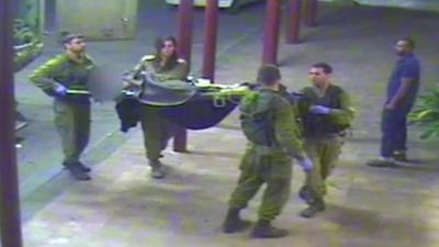CCTV frame showing Israeli soldiers carrying Syrian casualty into hospital