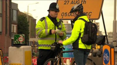 Police officer with cyclists