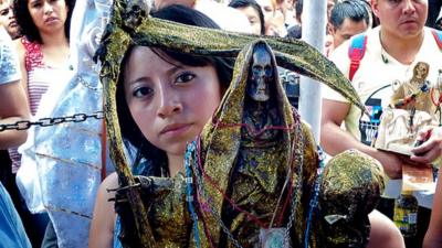 Devotee prays to Santa Muerte