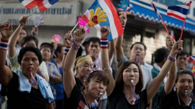 Anti-government protesters wave Thai national flags in Bangkok