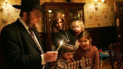 A Rabbi celebrating Hanukkah with his family