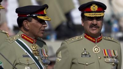 Pakistan"s outgoing army chief Gen. Ashfaq Kayani, left, talks with his successor Gen. Raheel Shari