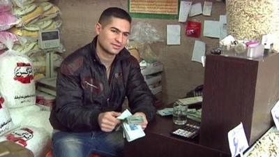 Man counts Iranian currency