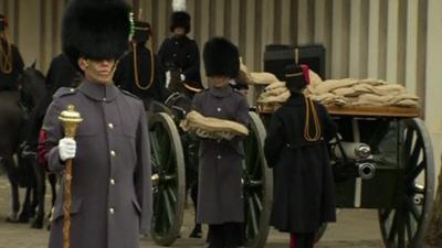 Soldiers from the Queens Foot Guards moving the sandbags of "sacred soil"