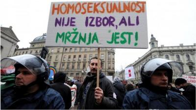 Protester holds sign reading "Homosexuality is not a choice, hate is a choice" in Zagreb