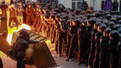 Protesters try to break through police lines near the presidential administration building during a rally held by supporters of EU integration in Kie