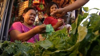 Woman selling food in street market