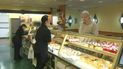 Staff and customers in a bakery