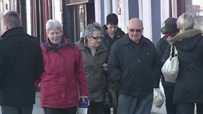 People walking down shopping street