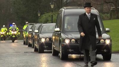 The funeral cortege, complete with honour guard of police outriders