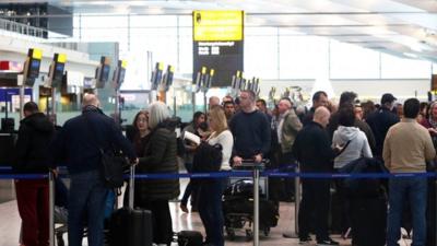 Queues of passengers at airport terminal