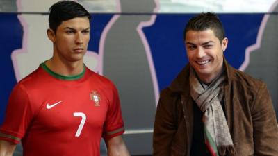 Cristiano Ronaldo stands next to wax figure of himself