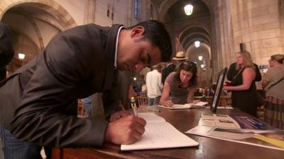 Congregants sign books of condolence at St George's Cathedral in Cape Town