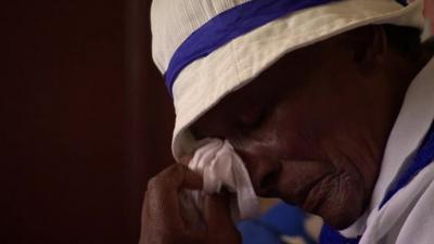 A member of the congregation of a church in Soweto sheds a tear at a memorial service for Nelson Mandela