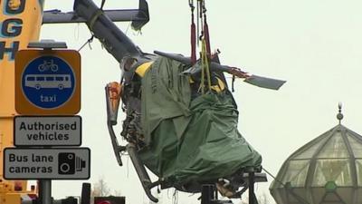 The helicopter being lifted from the crash site