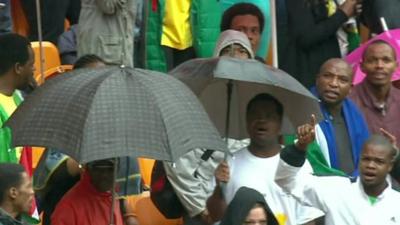 Crowd dancing under umbrellas