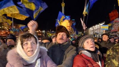 Protesters wave Ukrainian flags during an opposition rally on Independence Square in Kiev