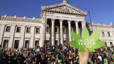 People participate in the so-called "Last demonstration with illegal marijuana" in front of the Congress building in Montevideo