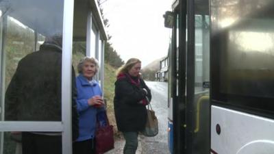 people boarding rural bus