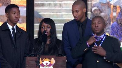 The sign language interpreter (far right) signs tributes by Nelson Mandela's grandchildren