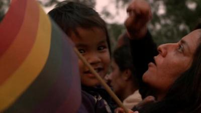 Small child with rainbow flag