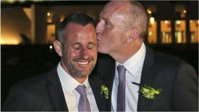 Western Australian politician Stephen Dawson, right, gives his husband Dennis Liddelow a kiss