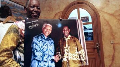 Pathe O with a picture of himself with Nelson Mandela