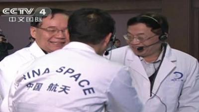 China's space mission team celebrate after the landing