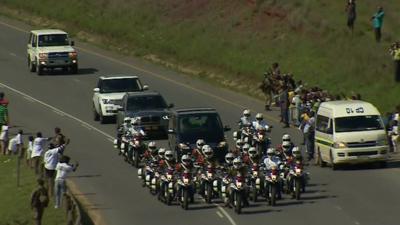 Hearse with motorcycle escort