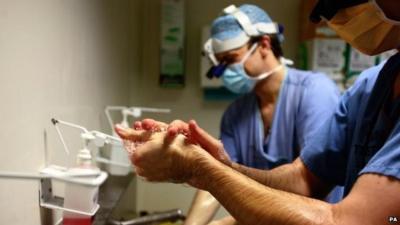 Doctors washing before surgery