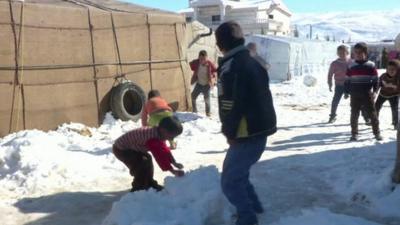 Syrian children playing in the snow at Arsal refugee camp