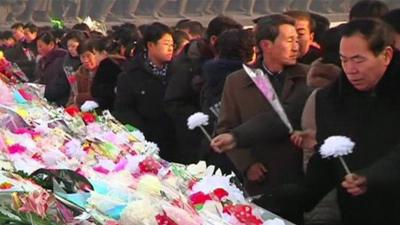 North Koreans lay flowers