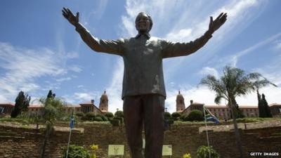 A statue of former South African president Nelson Mandela is unveiled at the Union Buildings on December 16, 2013 in Pretoria