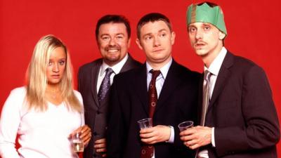 Characters from BBC's The Office at a Christmas party