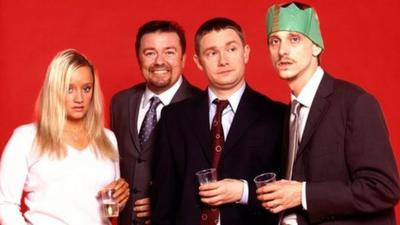 Characters from BBC's The Office at a Christmas party