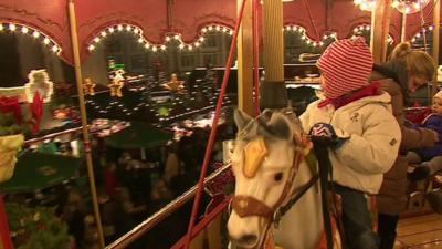 Child on carousel fair ground ride