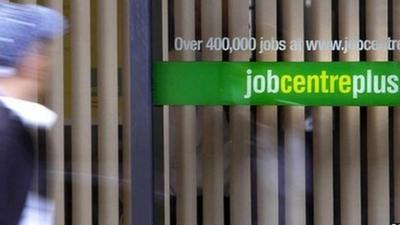 Man in front of Job Centre window