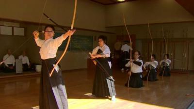 People practise archery