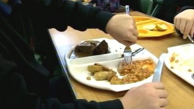 Pupils eat school dinner