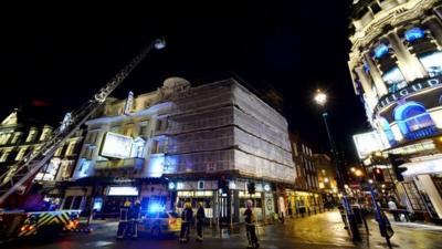 Members of the emergency services work at the scene of a roof collapse at The Apollo Theatre