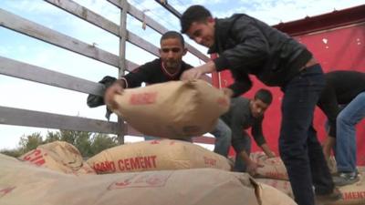 Traders deliver cement at the Oncupinar border between Syria and Turkey