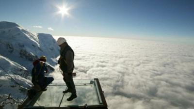 Workmen complete mountain top glass platform