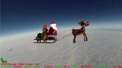 An cartoon image of Santa and a reindeer in the sky