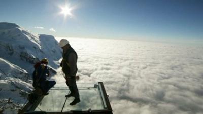 Workmen complete mountain top glass platform