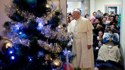 Pope Francis next to Christmas tree