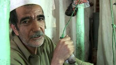 Gol Ahmad operates his 100 year old silk weaving machine