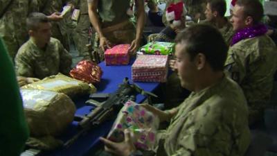 Armed forces personnel with presents and decorations in Camp Bastion