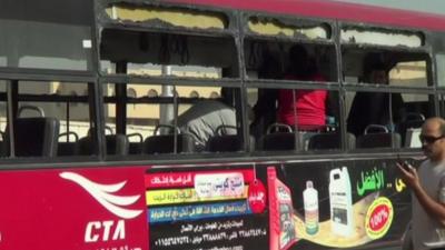 Blown out windows along the side of the bus