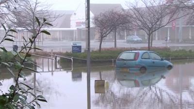 Car up to its wheel arches abandoned