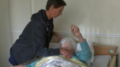 A resident in bed at the Grange Nursing Home in Sherborne St John